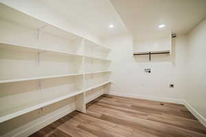 Laundry area featuring washer hookup, recessed lighting, light wood-type flooring, and hookup for an electric dryer
