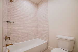 Bathroom with toilet and bathtub / shower combination