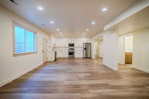 Unfurnished living room with recessed lighting and light wood-style floors