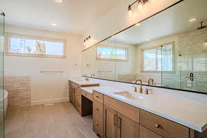 Bathroom with double vanity, a stall shower, a soaking tub, and recessed lighting