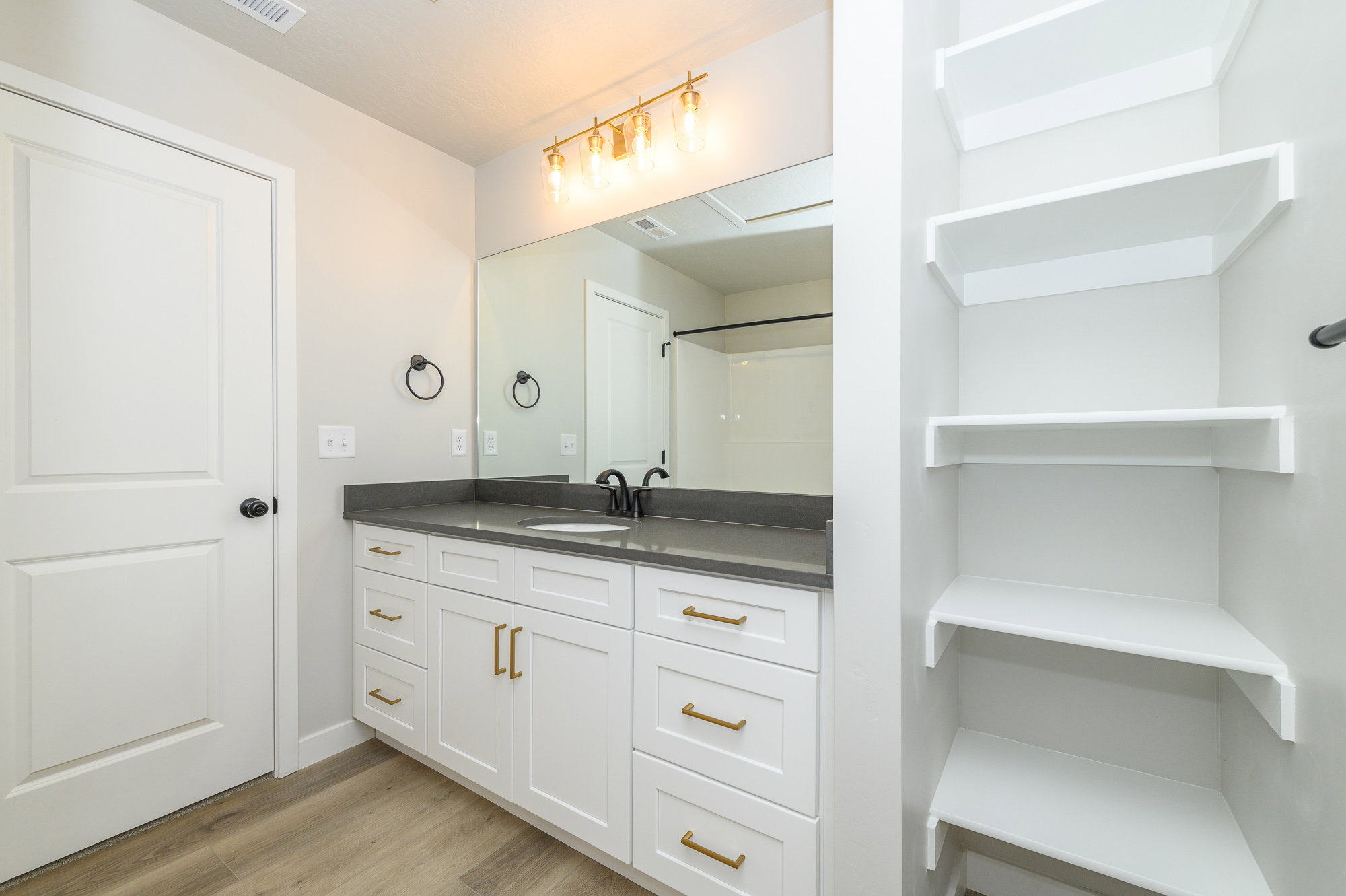 Full bathroom with vanity and light wood-style flooring