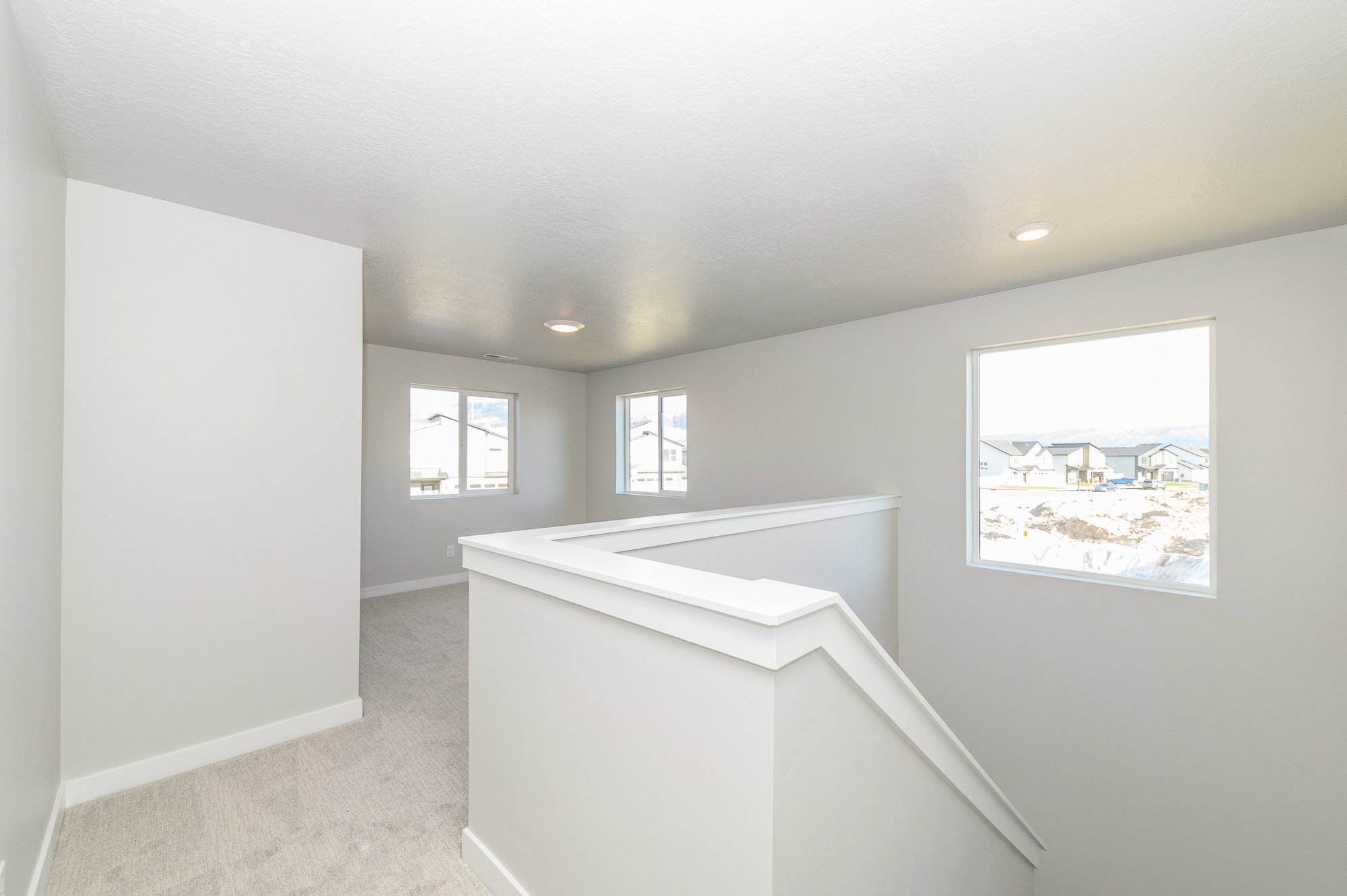Hall with an upstairs landing and light carpet