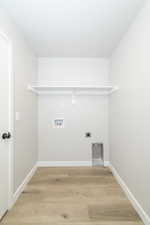 Laundry room with light wood finished floors, electric dryer hookup, and hookup for a washing machine