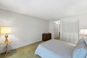 Bedroom with carpet and a textured ceiling