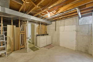 Unfinished basement featuring washer and dryer