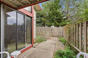 Fenced backyard featuring a gate