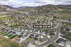 Aerial view of property's location featuring a mountainous background and nearby suburban area