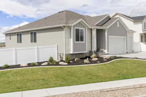 View of front of house with an attached garage, roof with shingles, board and batten siding, and driveway