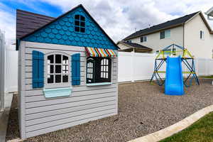View of outdoor structure with a fenced backyard