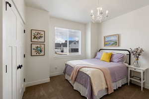 Bedroom with hanging lights and dark carpet