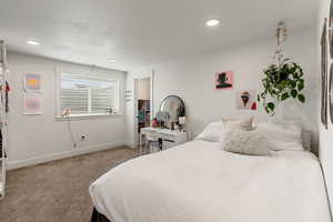Carpeted bedroom featuring baseboards and recessed lighting