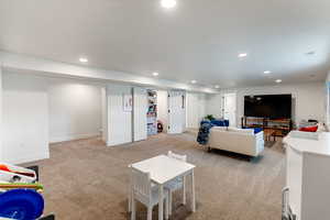 Living area featuring recessed lighting and light colored carpet