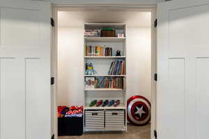 Recreation room featuring dark carpet