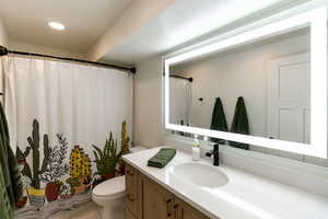 Bathroom featuring vanity and a shower with shower curtain