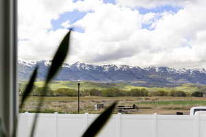 View of mountain backdrop with rural landscape