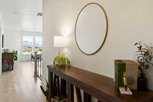 Corridor with a mountain view and light wood-style flooring