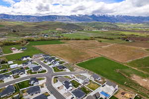 Aerial view of sparsely populated area with mountains and nearby suburban area