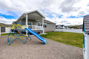 View of playground with a fenced backyard