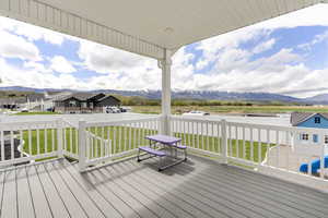 Wooden deck featuring a mountain view and a residential view