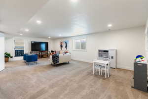 Living area with light carpet and recessed lighting