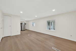 Unfurnished living room with light wood-style floors and recessed lighting