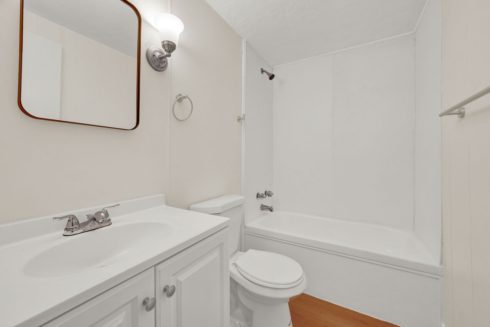 Full bathroom featuring vanity, shower / bath combination, and light wood-type flooring