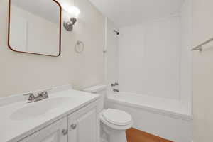 Full bathroom featuring vanity, shower / bath combination, and light wood-type flooring