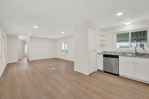 Kitchen featuring open shelves, dishwasher, light wood-style flooring, recessed lighting, and white cabinets