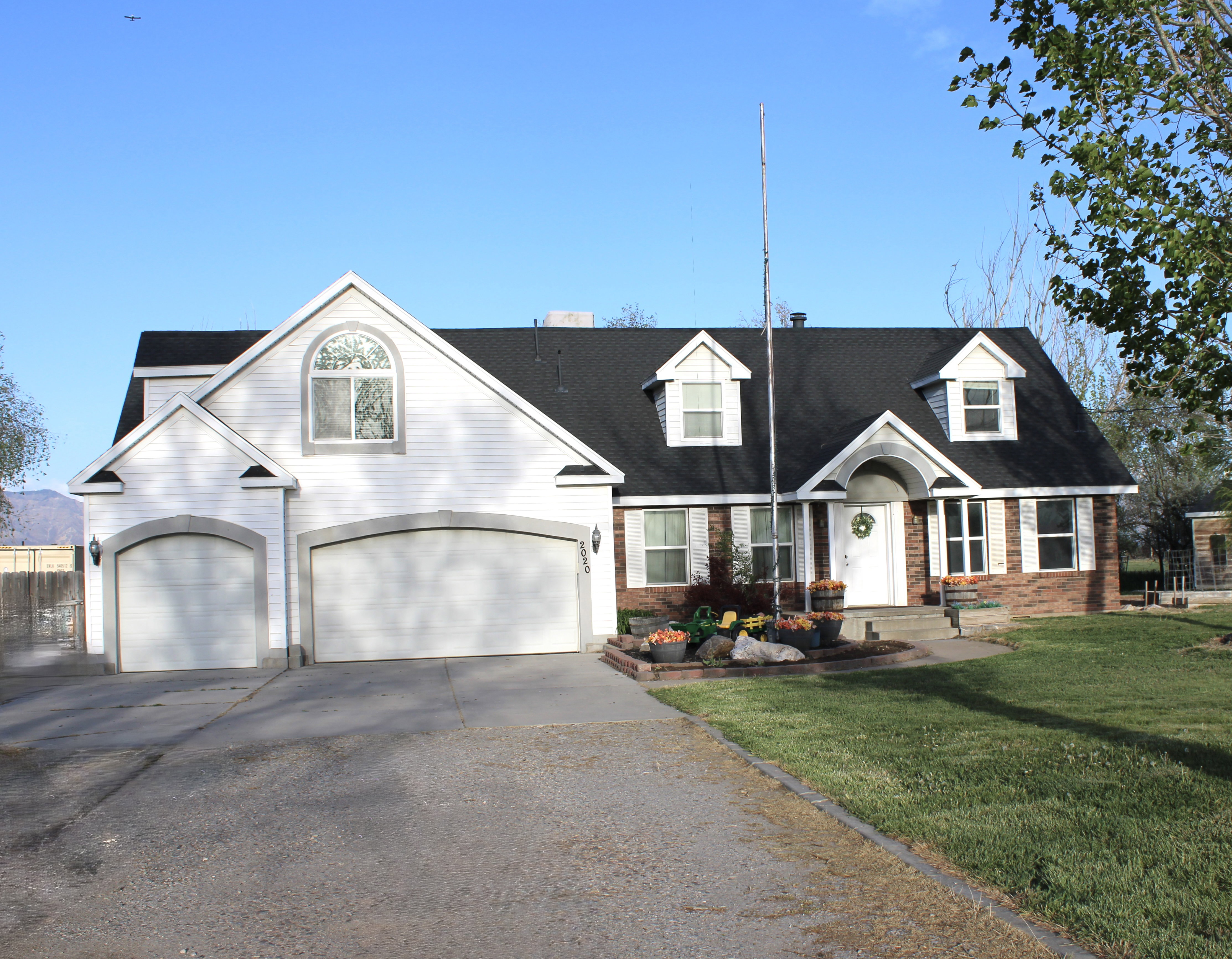 View of front of house with brick siding, and a garage