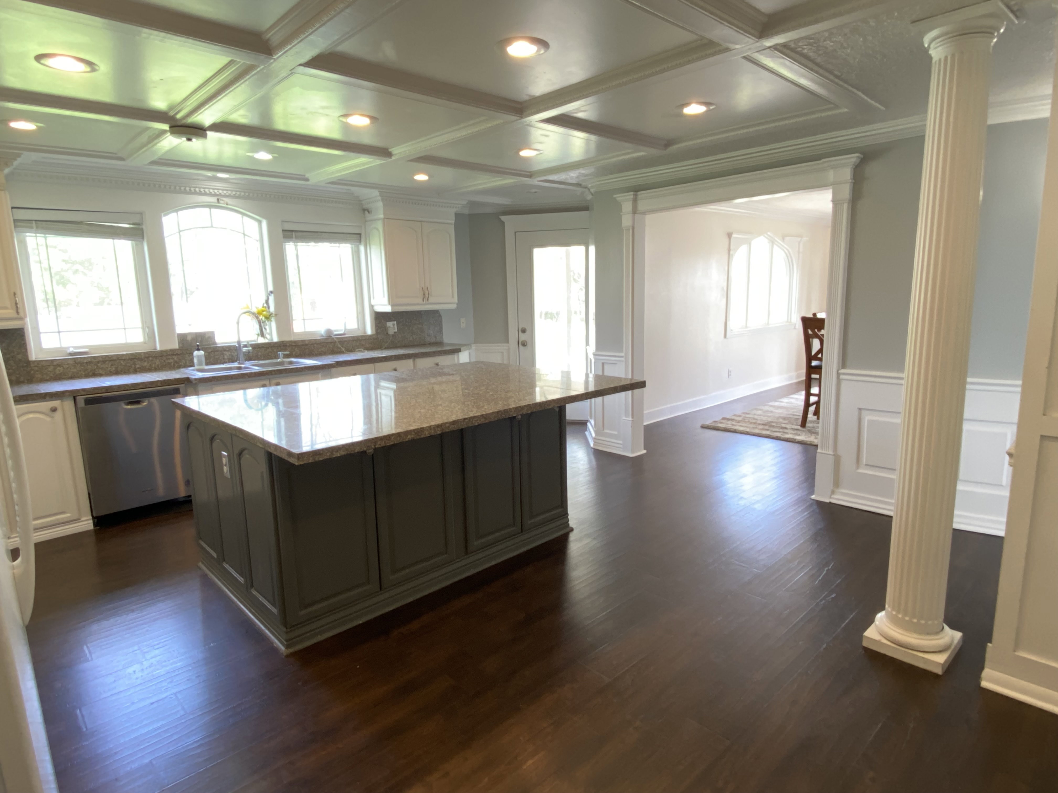 Kitchen with decorative columns and large dining room