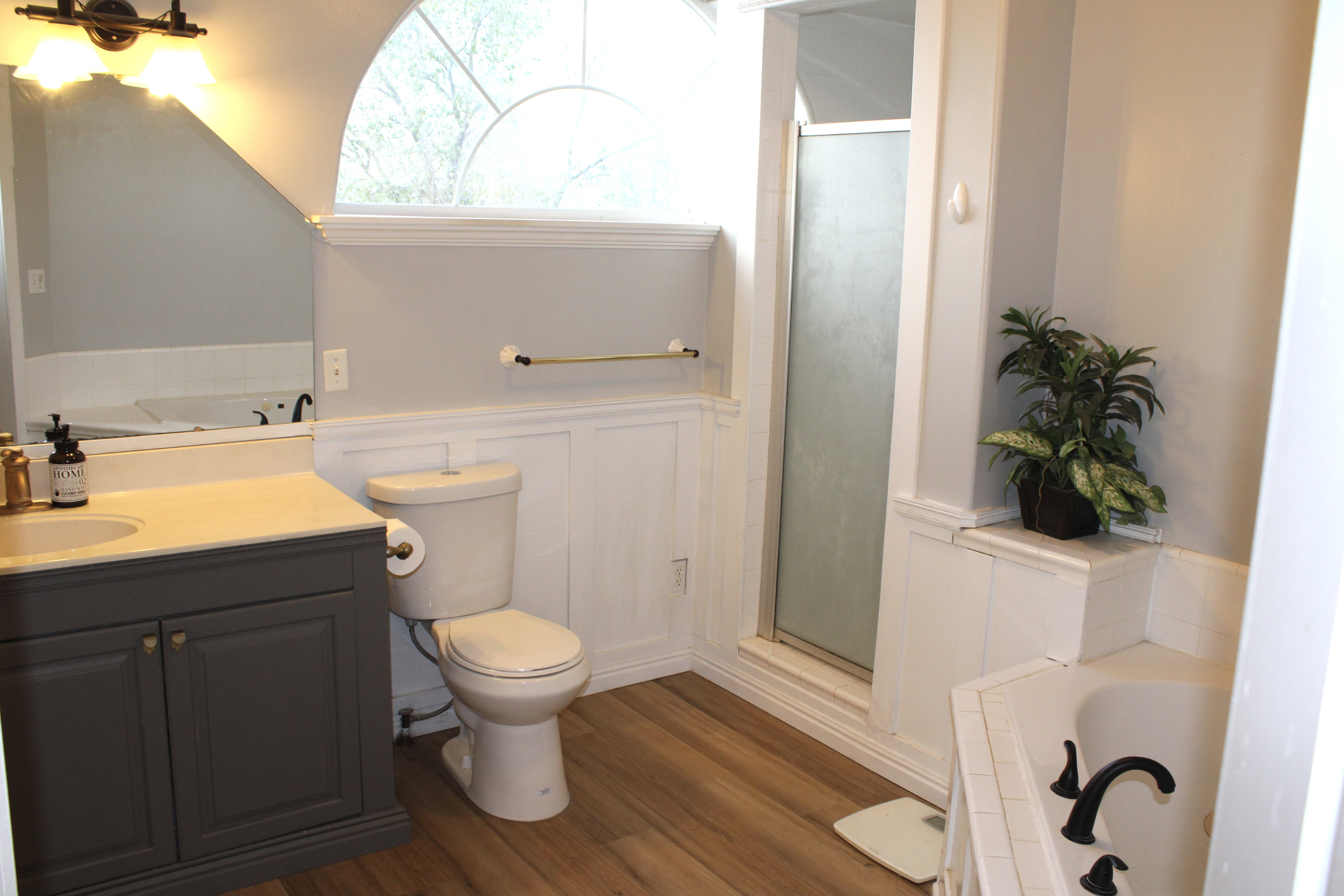 Bathroom with a garden tub, wainscoting