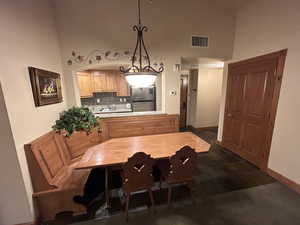 Dining area with baseboards and a high ceiling