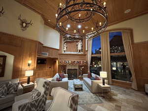 Common area with wooden walls and a high wooden ceiling