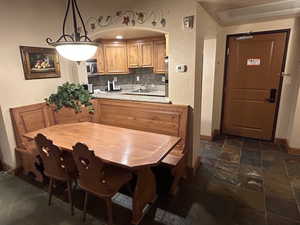 Dining area featuring arched walkways and stone tile floors