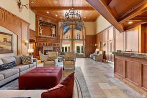 Building lobby with a high wooden beamed ceiling, a decorative wall, and recessed lighting