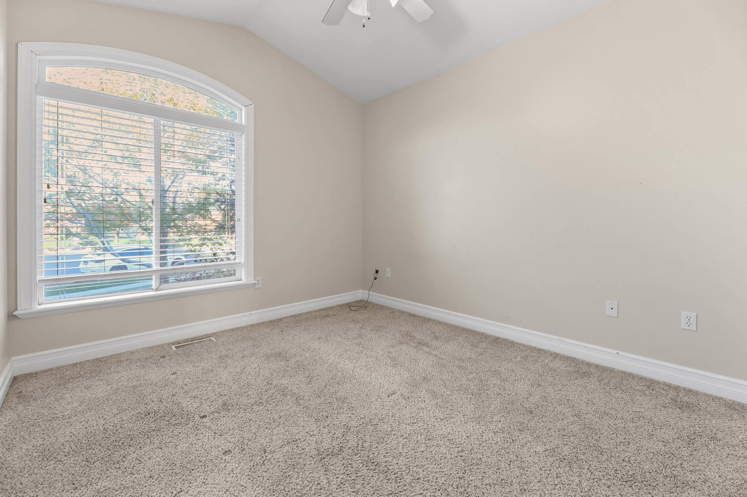 Bedroom 3 with light carpet, vaulted ceiling, and ceiling fan