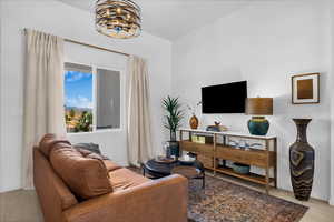 Living room with wood finished floors and a chandelier