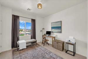 Office area featuring baseboards and light wood-style floors