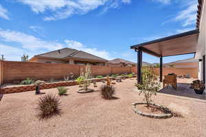 Fenced backyard featuring a patio
