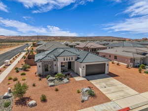 Mediterranean / spanish house with stucco siding, driveway, a garage, a residential view, and stone siding