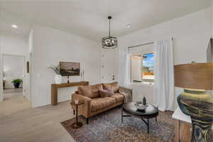Living area featuring wood finished floors and suspended lighting
