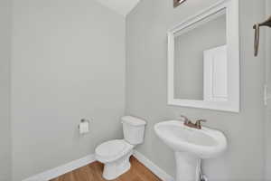 Bathroom with baseboards and wood finished floors
