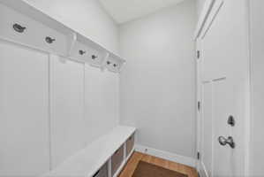 Mudroom featuring light wood finished floors and baseboards