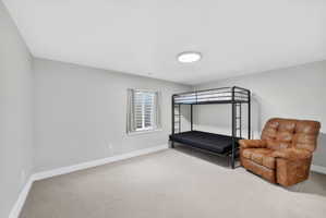 Bedroom featuring baseboards and light colored carpet
