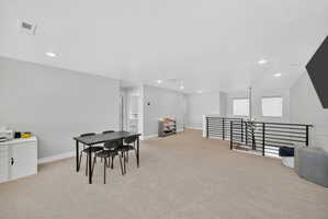 Rec room featuring light carpet, recessed lighting, and a textured ceiling