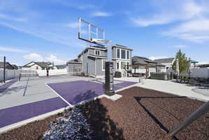 View of sport court with basketball hoop, a residential view, and a gazebo