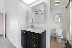 Full bathroom with vanity and toilet