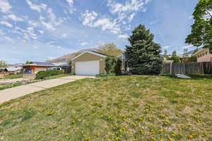 View of front of home with concrete driveway, a mountain view, and a garage