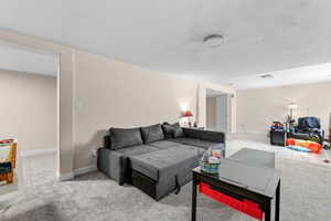 Living area with carpet floors and baseboards