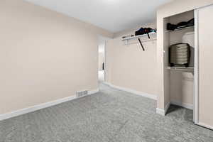 Unfurnished bedroom featuring a closet and light carpet